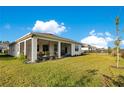 Spacious backyard with a screened patio and lush lawn at 17543 Saw Palmetto Ave, Clermont, FL 34714