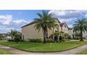 Tan two-story house with palm trees and a landscaped yard at 1827 Pisgah Ln, Apopka, FL 32712