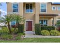 Front entrance with a red door, landscaping, and a walkway at 1827 Pisgah Ln, Apopka, FL 32712