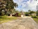 Brick ranch home with long driveway and mature trees at 227 N Kepler Rd, Deland, FL 32724