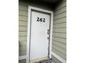 White front door of the condo building with the number 262 at 262 Scottsdale Sq # 262, Winter Park, FL 32792