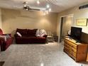 Living room with tile floors, red couches, and a wooden dresser at 262 Scottsdale Sq # 262, Winter Park, FL 32792
