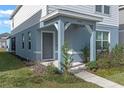 Gray front door with a covered porch and walkway at 4074 Roaming Brook Dr, Apopka, FL 32712