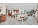 Open concept dining room with large table and adjacent kitchen at 611 Lasso Dr, Kissimmee, FL 34747