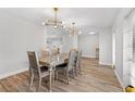 Elegant dining room with modern light fixtures and hardwood floors at 6829 Bittersweet Ln, Orlando, FL 32819