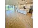 Open concept kitchen with island and stainless steel appliances at 7520 Castlewood Ct, Harmony, FL 34773