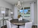 Dining room with round table, chandelier, and access to a patio at 1104 Western Blue Way, Minneola, FL 34715