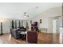 Spacious living room featuring hardwood floors, a ceiling fan, and comfortable seating at 1311 Plover Ct, Groveland, FL 34736