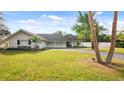 Charming ranch home with a spacious lawn and palm trees at 1860 Linden Rd, Winter Park, FL 32792