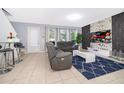 Open living room with gray sofas and a statement wall at 664 Benoi Dr, Davenport, FL 33896