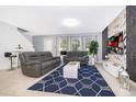 Bright living room featuring comfortable sofas and large windows at 664 Benoi Dr, Davenport, FL 33896