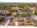 House with pool in a residential neighborhood with a pond nearby at 6928 Sugarbush Dr, Orlando, FL 32819