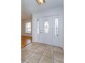 Bright entryway with tile flooring and an elegant stained-glass door at 6928 Sugarbush Dr, Orlando, FL 32819