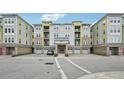 Modern apartment building with parking and landscaping at 7517 Laureate Blvd # 4205, Orlando, FL 32827