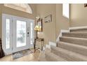 Bright entryway with tile flooring, staircase, and glass front door at 817 Suffolk Pl, Davenport, FL 33896