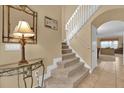 Entryway with staircase, showing view into living room at 817 Suffolk Pl, Davenport, FL 33896