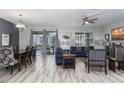 Open living and dining area with hardwood floors and access to patio at 1550 Observer Ln, Davenport, FL 33896