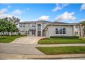 Two-story house with stone exterior, paver driveway and landscaping at 2205 Lake Sylvan Oaks Ct, Sanford, FL 32771