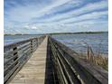 Wooden dock extending over calm lake water at 4324 S Kirkman Rd # 1, Orlando, FL 32811