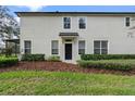 Rear view of the townhome, showing a private backyard and manicured landscaping at 6292 Twain St # 101, Orlando, FL 32835