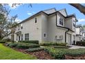 Two-story townhome showcasing its side profile and neatly landscaped yard at 6292 Twain St # 101, Orlando, FL 32835