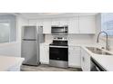 Modern kitchen featuring stainless steel appliances and white shaker cabinets at 1500 Gay Rd # 7A, Winter Park, FL 32789