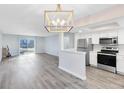 Open concept kitchen with stainless steel appliances and light grey vinyl flooring at 1500 Gay Rd # 7A, Winter Park, FL 32789