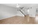 Living room featuring tile floors, staircase, and ceiling fan at 2209 Tipperary Ct # 1, Orlando, FL 32812