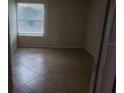 Simple bedroom with tile floor and window at 4572 Commander Dr # 1227, Orlando, FL 32822