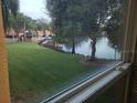View of lake from window, green space, and buildings at 4572 Commander Dr # 1227, Orlando, FL 32822