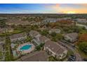 Community view showcasing a pool, townhomes, and ample parking at 5269 Wellington Park Cir # 23, Orlando, FL 32839