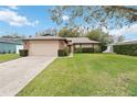 Brick ranch house with attached garage and large yard at 8916 Brackenwood Dr, Orlando, FL 32829