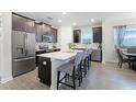 Modern kitchen with stainless steel appliances and an island with seating at 12128 Illustration Dr, Orlando, FL 32832