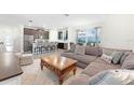 Open living area featuring a large sectional sofa and a wooden coffee table at 12128 Illustration Dr, Orlando, FL 32832