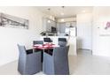 Bright dining area with glass table and four grey chairs at 1784 Coriander Dr, Kissimmee, FL 34759