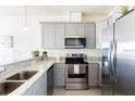 Modern kitchen featuring stainless steel appliances and granite countertops at 1784 Coriander Dr, Kissimmee, FL 34759