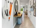 Inviting entryway with wood console table, mirror, and stylish wall decor at 2766 Puffin Pl, Davenport, FL 33837