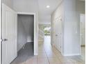Bright hallway with tile flooring and access to other rooms at 4775 Terrasonesta Dr, Davenport, FL 33837