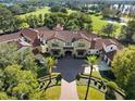 Luxury home with pool, beautiful landscaping, and golf course views at 5271 Isleworth Country Club Drive, Windermere, FL 34786