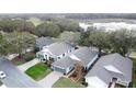 Community overview showcasing homes near a body of water and golf course at 25001 Cranes Roost Cir, Leesburg, FL 34748