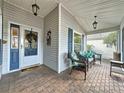 Screened porch with wicker furniture and brick flooring at 25001 Cranes Roost Cir, Leesburg, FL 34748