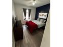 Spacious bedroom with a red blanket and a modern feel at 259 Grand Rapids Dr, Poinciana, FL 34759