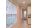 Bright hallway with tile flooring and large windows at 573 Lago Matisse St, Kissimmee, FL 34759
