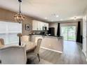 Bright dining area with a round table and chairs, adjacent to kitchen at 1030 Bending Oak Trl, Winter Garden, FL 34787