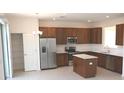 Modern kitchen with stainless steel appliances and an island at 2553 Shanti Dr, Kissimmee, FL 34746
