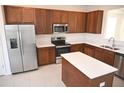 Modern kitchen with stainless steel appliances and an island at 2553 Shanti Dr, Kissimmee, FL 34746