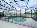 Screened-in pool and patio overlooking a lake at 2553 Shanti Dr, Kissimmee, FL 34746