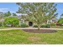 House exterior with lush green lawn and mature trees at 333 N Spaulding Cv, Lake Mary, FL 32746