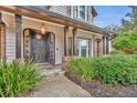 Elegant front entrance with dark brown door and brick columns at 333 N Spaulding Cv, Lake Mary, FL 32746
