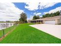 Spacious backyard with a large grassy area, a dock, and a view of the lake at 3651 S Rosalind Ave, Orlando, FL 32806